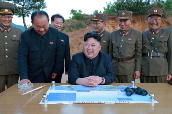 FILE PHOTO: North Korean leader Kim Jong Un reacts during the long-range strategic ballistic rocket Hwasong-12 (Mars-12) test launch