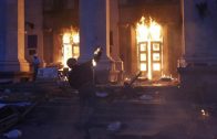 A protester throws a petrol bomb at the trade union building in Odessa